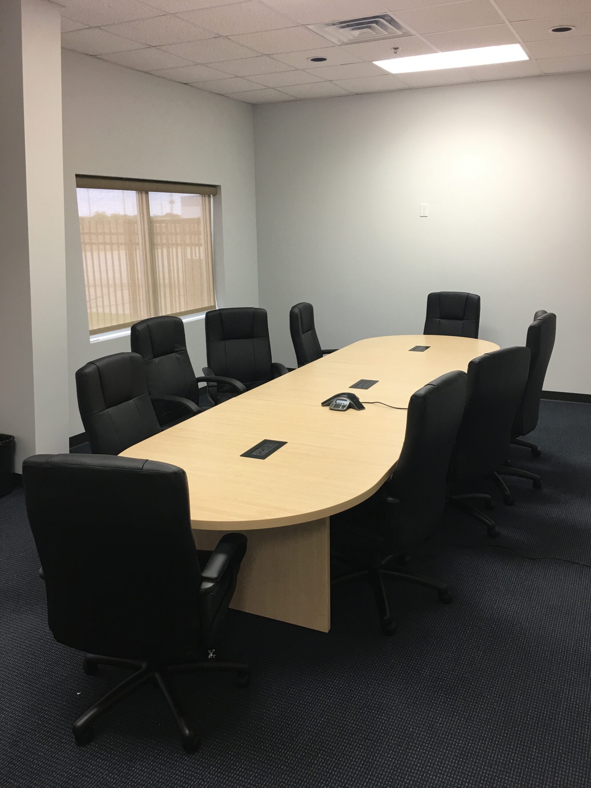 Blonde Conference Table with Black Chairs